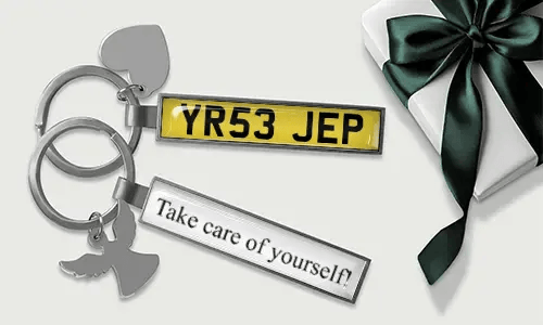 Personalized license plate keychain with heart and wing charms