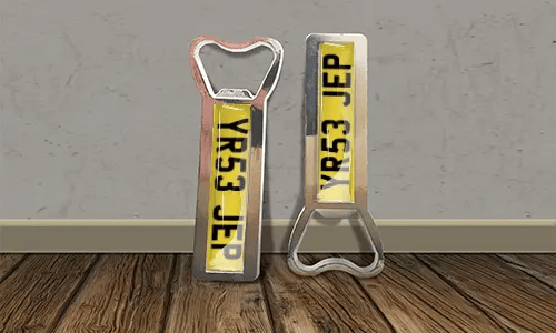 two bottle opener magnets on the floor