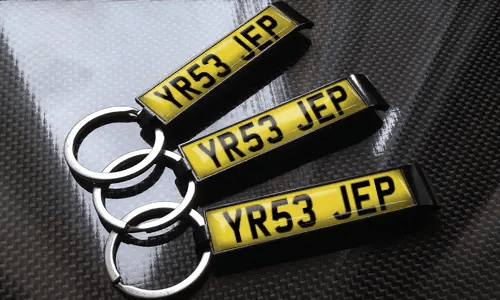 three bottle opener keychains with flags