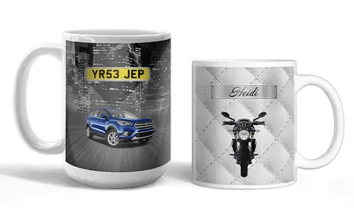 Two white mugs with vehicle-themed prints: blue SUV with city lights, motorcycle with quilted silver background and name Heidi