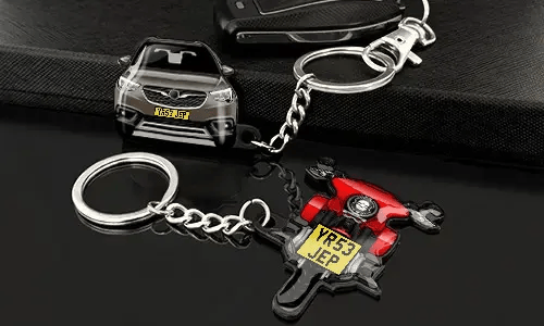 Car and motorcycle keychains displayed with detailed vehicle designs