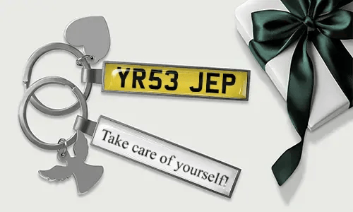 Metal license plate keychain with heart and angel wing charms