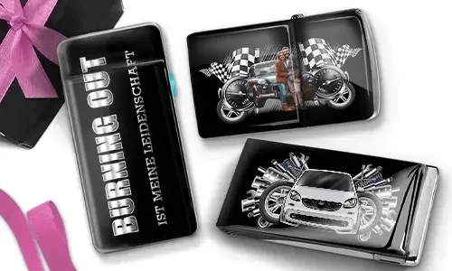 Three glossy cigarette cases with automotive themes. One reads 