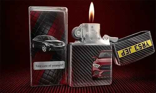 Flip-top lighter with flame: red car on carbon fiber background, black car with name JONAS on quilted panel