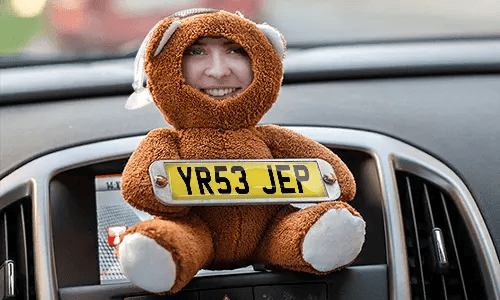 Cuddly toy with photo in the car