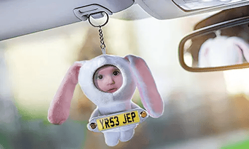 Cuddly toy bunny with photo in the car Cuddly toy bunny with photo in the car