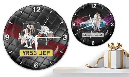 Two wall clocks with family and car scenes: left with trunk picnic on quilted background, right with blue sports car and couple over purple wave