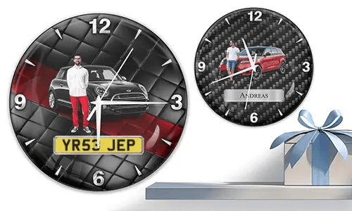 Two wall clocks with male figures and cars: left with black car on quilted background, right with red car and carbon texture